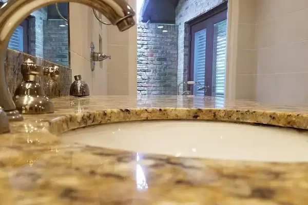 A Counter With A Sink And A Mirror