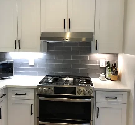 A Stove Top Oven Sitting Inside Of A Kitchen