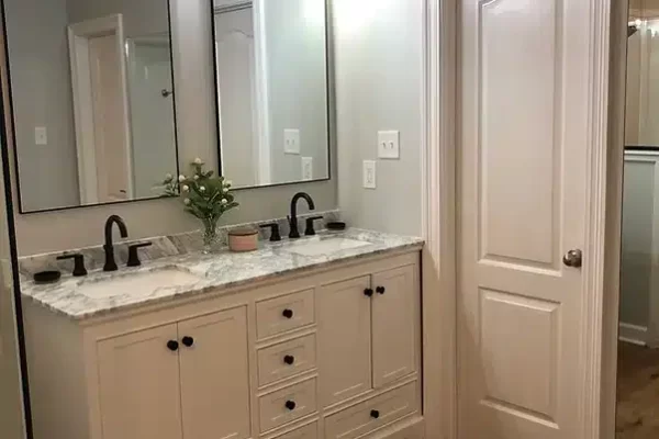 A Kitchen With A Sink And A Mirror
