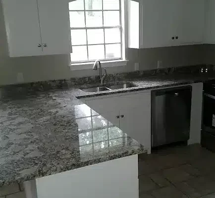 A Kitchen With A Sink And A Window