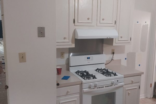 A Kitchen With A Stove Top Oven Sitting Inside Of A Refrigerator