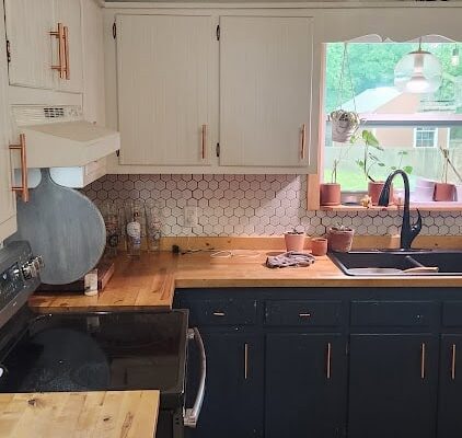 A Kitchen With A Stove And A Sink