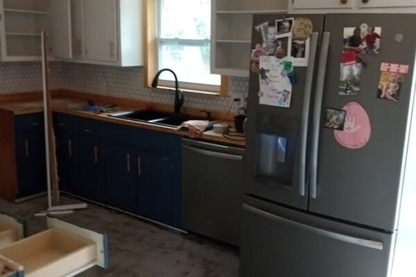 A Large Kitchen With Stainless Steel Appliances