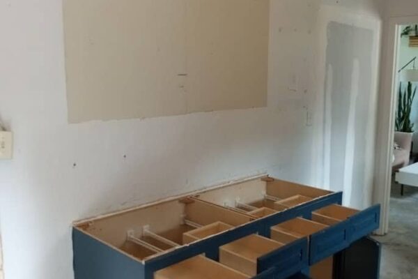 A Kitchen With Wooden Cabinets And A Sink