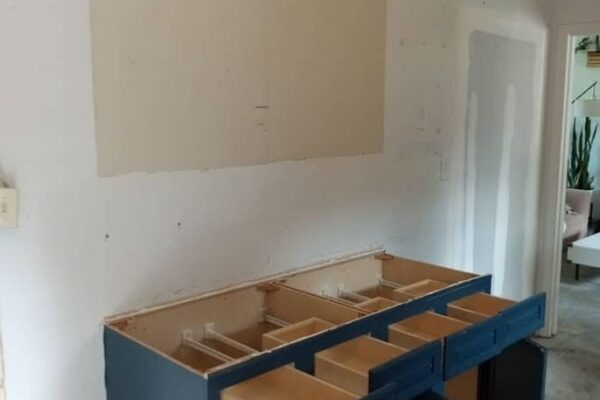 A Kitchen With Wooden Cabinets And A Sink