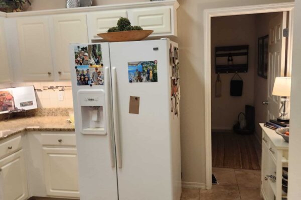 A Kitchen With A Sink And A Refrigerator