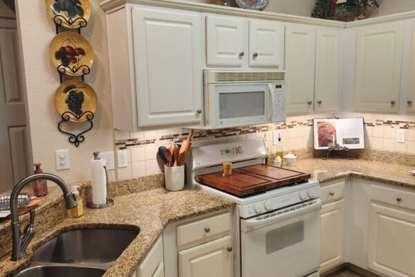 A Kitchen With A Stove And A Sink