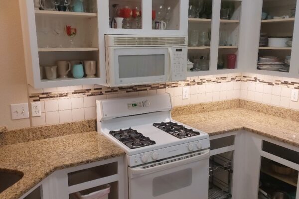 A Stove Top Oven Sitting Inside Of A Kitchen
